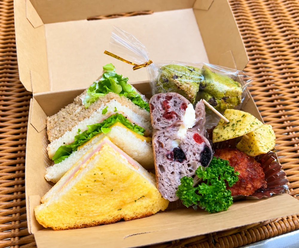 Inside a morning sandwich box: sandwiches, savory bread and baked sweets