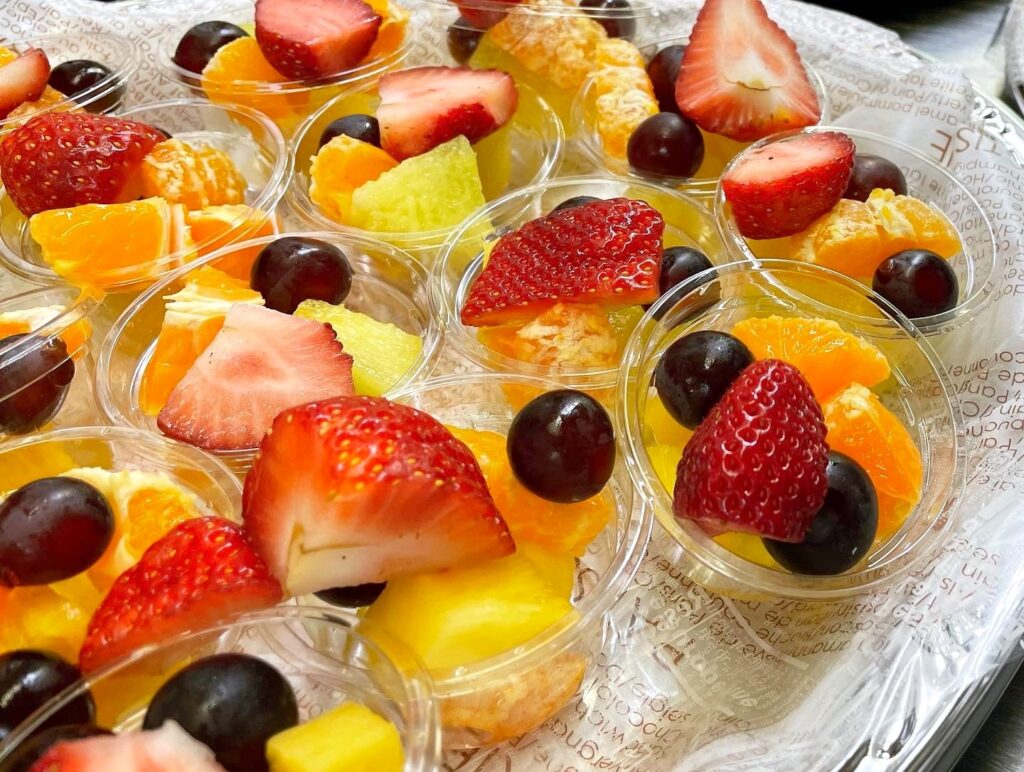 Fruit cups with strawberries, grapes, oranges and more